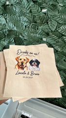 Personalized beige paper napkins with printed dog portraits and the text 'Drinks on us! Lincoln & Bruno 09.24.