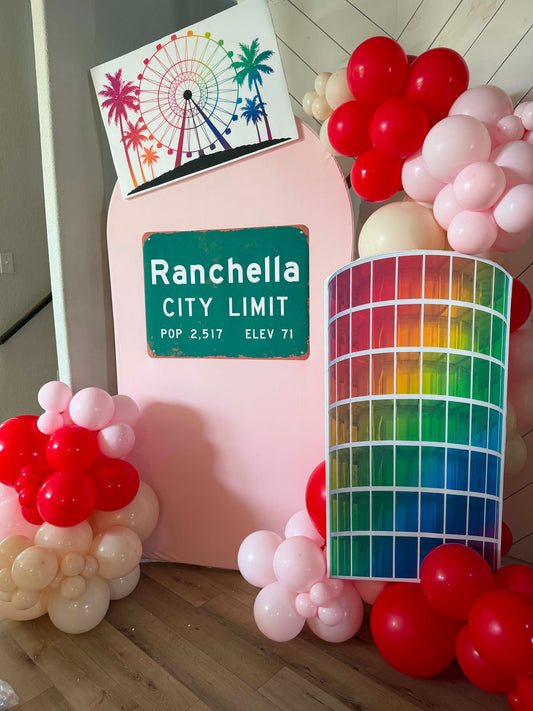 Custom printed event graphics displayed with balloons and colorful backdrop panels