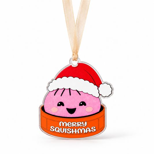 pink Merry Squishmas acrylic ornament with red Santa hat, one centered clear top tab and beige ribbon.