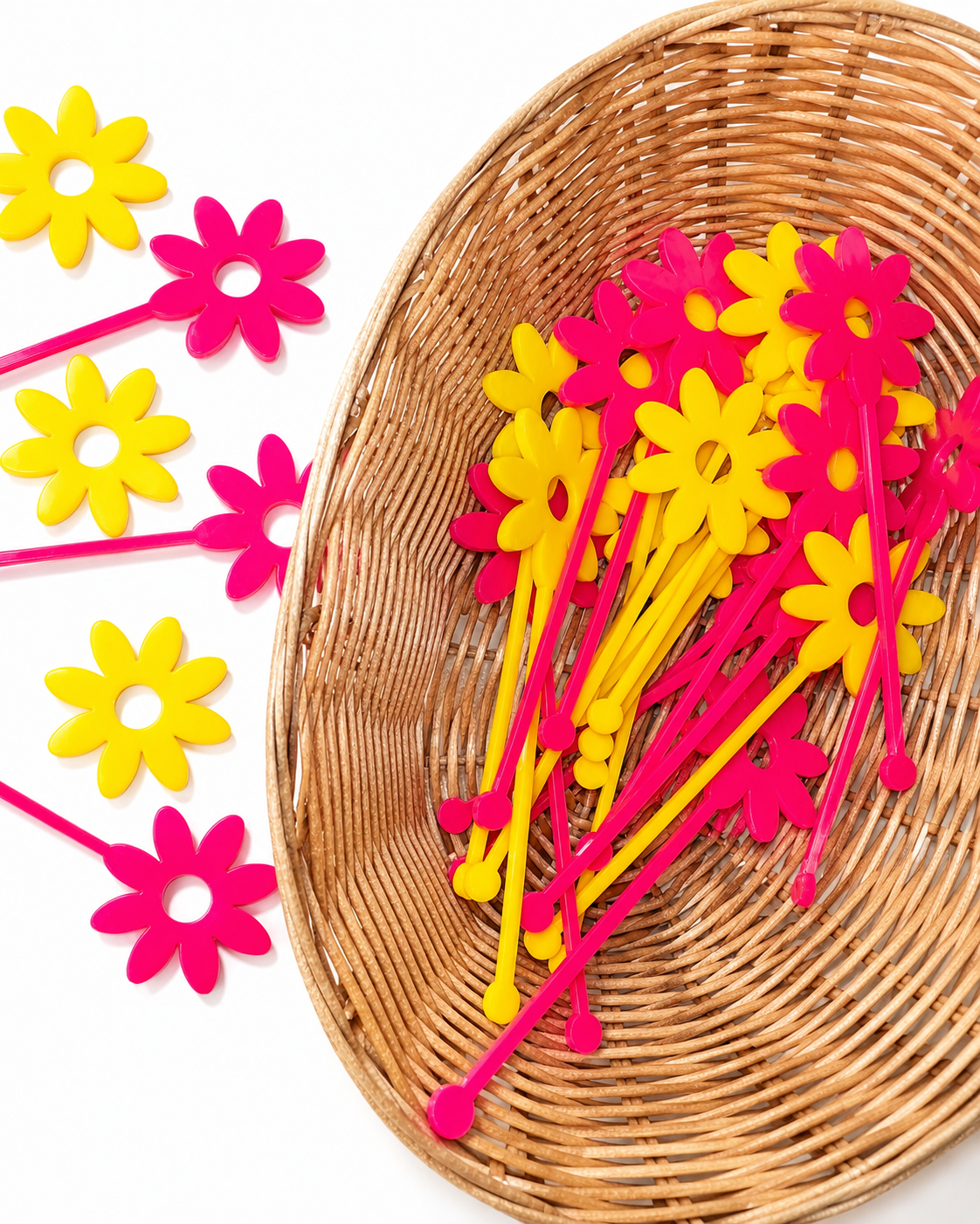 Pink and yellow flower shaped drink stirrers