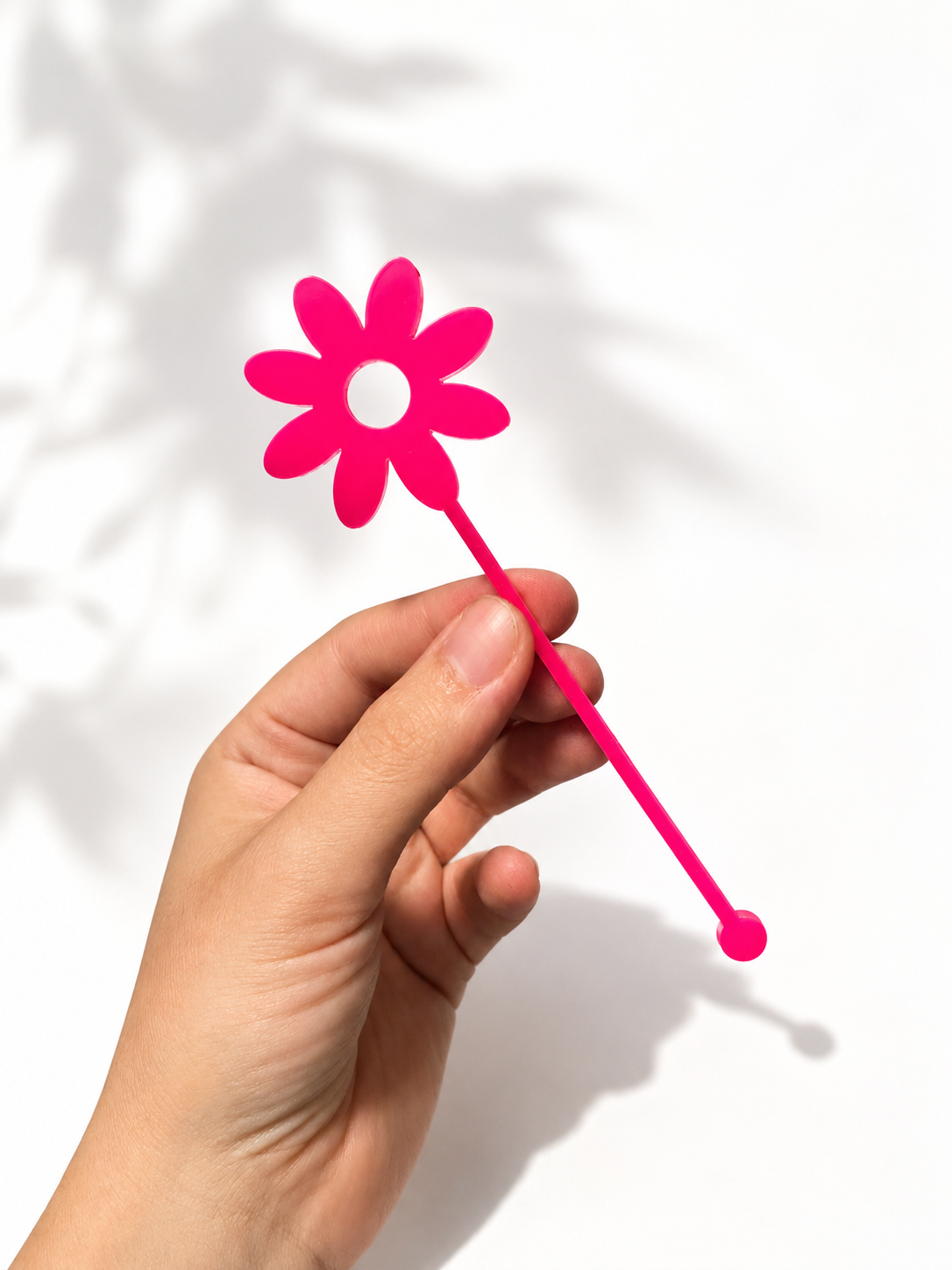 Pink and yellow flower shaped drink stirrers