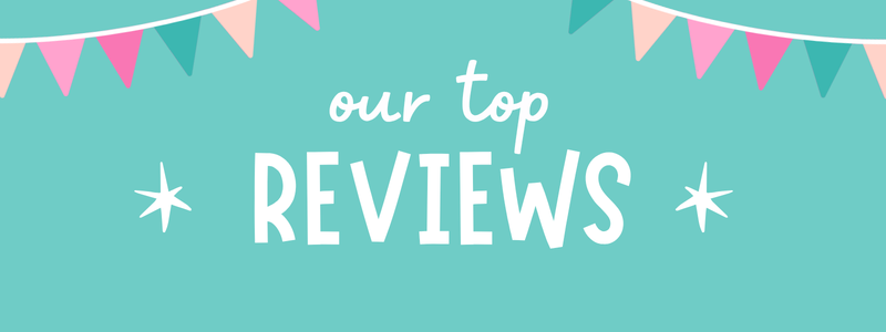 A digital graphic banner with a teal background, featuring the text 'our top REVIEWS' in white. The top of the banner is decorated with pink, teal, and peach triangular bunting flags, and there are two white starburst icons on either side of the word 'REVIEWS'.