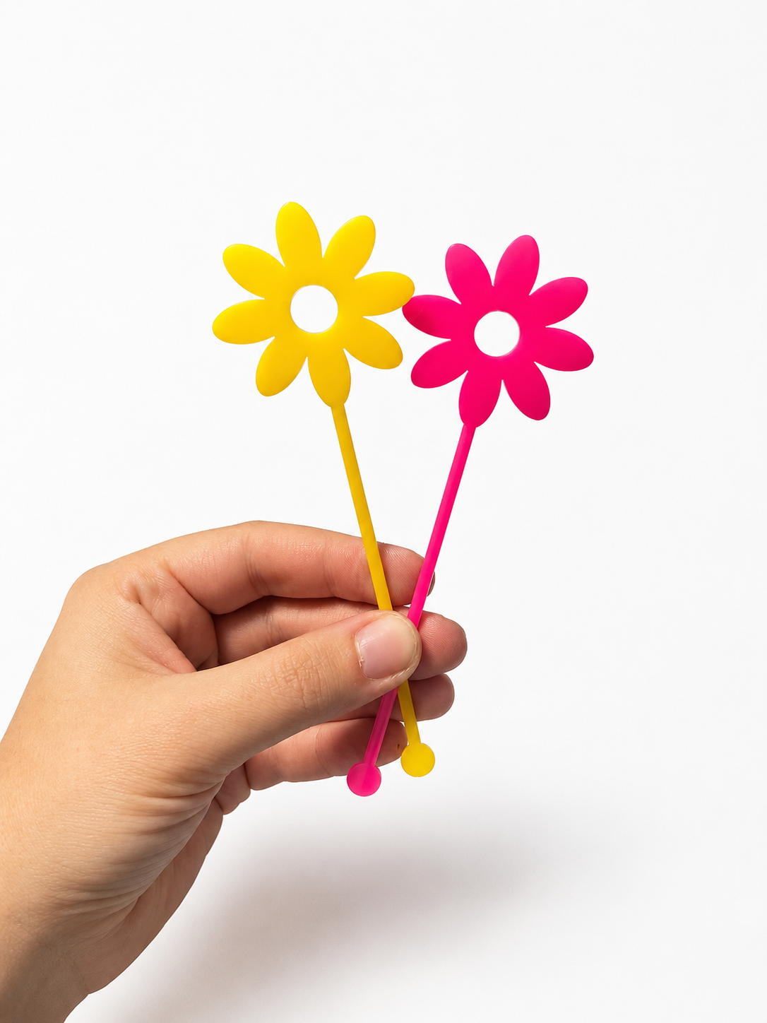 Pink and yellow flower shaped drink stirrers