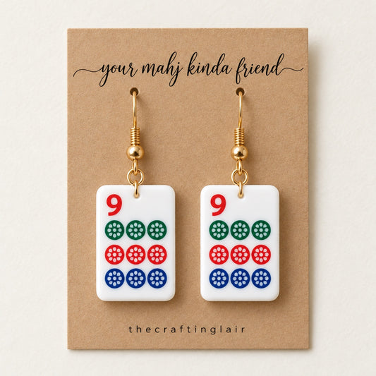 Nine-dot white acrylic mahjong earrings on a kraft card reading your mahj kinda friend by The Crafting Lair.