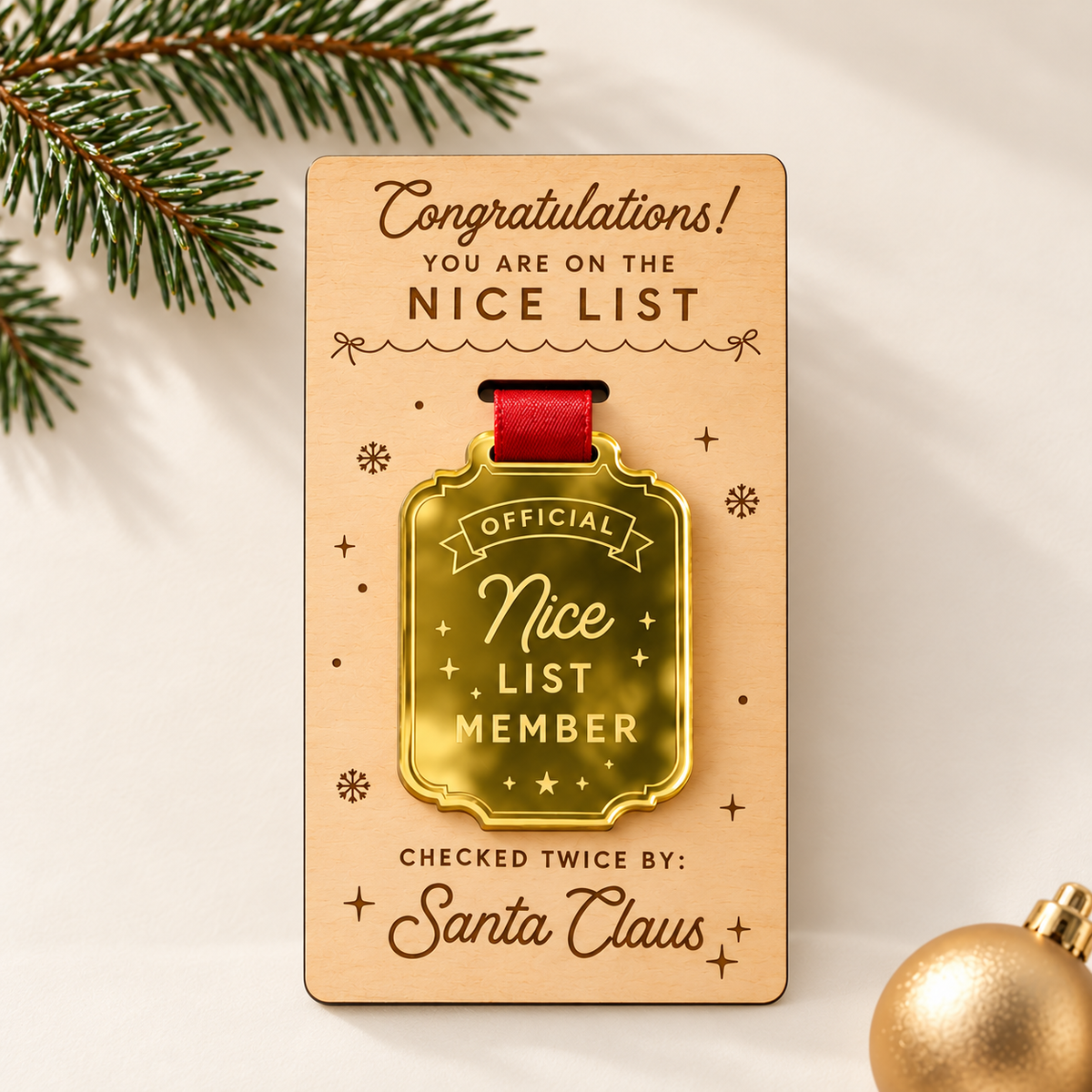 Official Nice List Member rectangular gold mirror award with red ribbon and Congratulations engraved wooden presentation card.