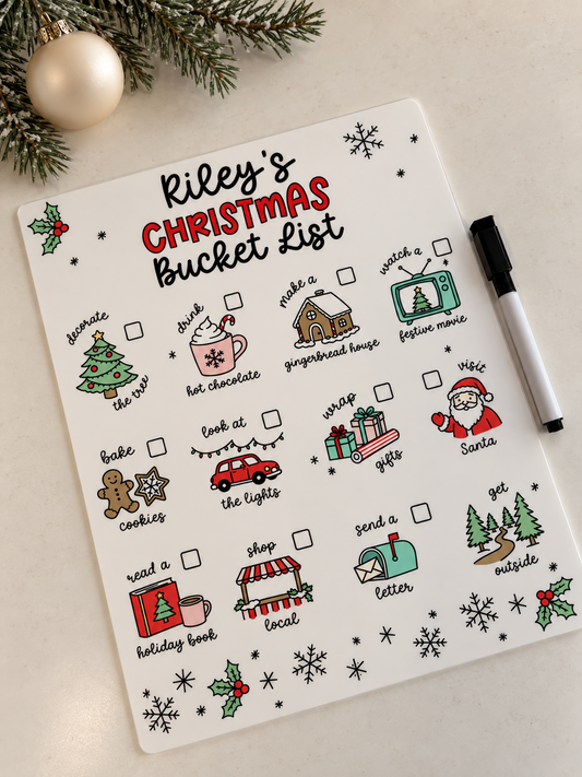 Personalized Christmas bucket list acrylic dry-erase board with Riley's name, 12 illustrated holiday activities and a marker beside it.