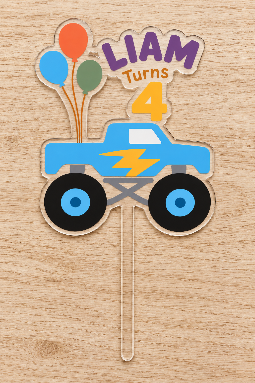 Personalized blue lightning monster truck birthday cake topper with custom name and age on clear acrylic