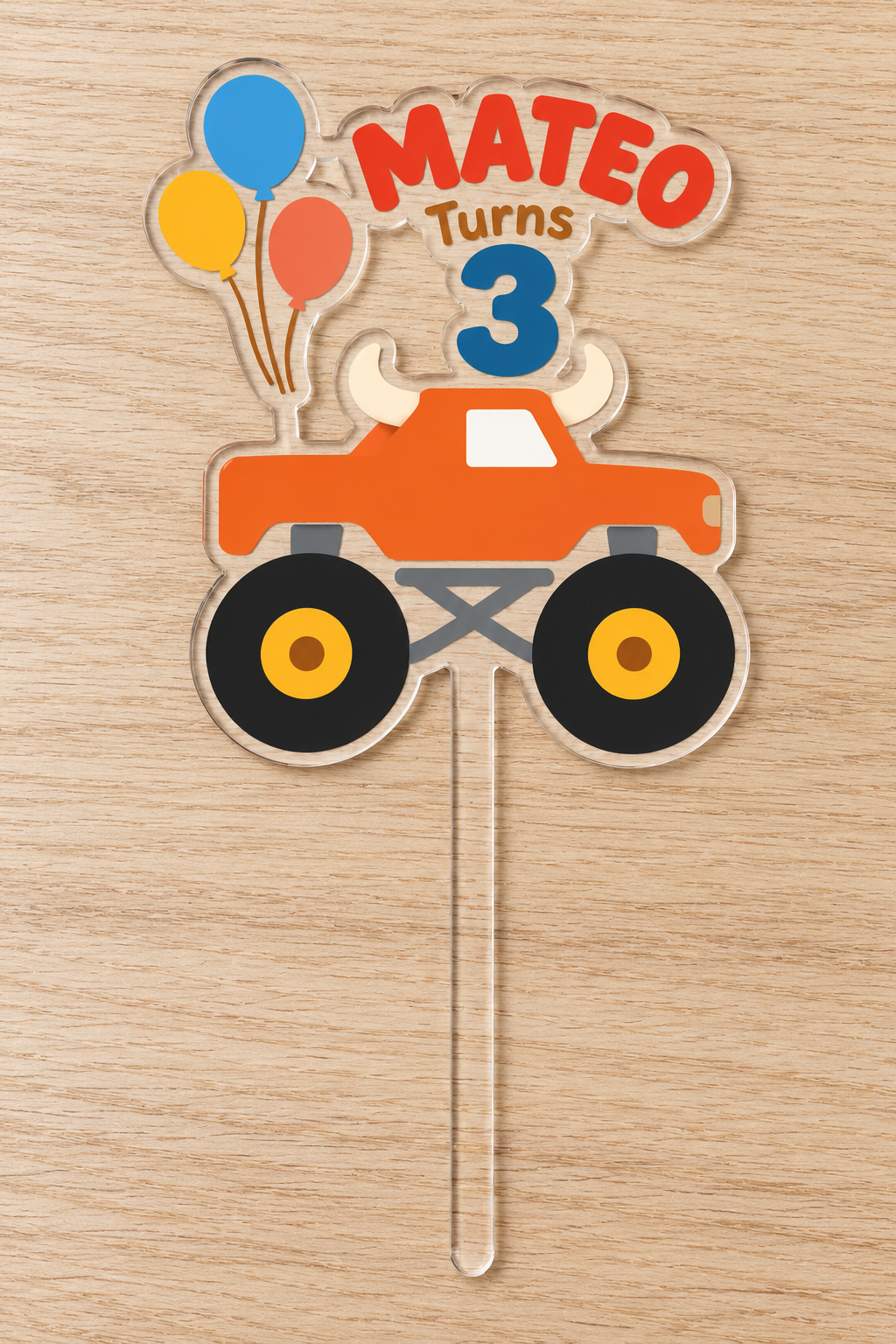 Personalized orange bull monster truck birthday cake topper with custom name and age on clear acrylic