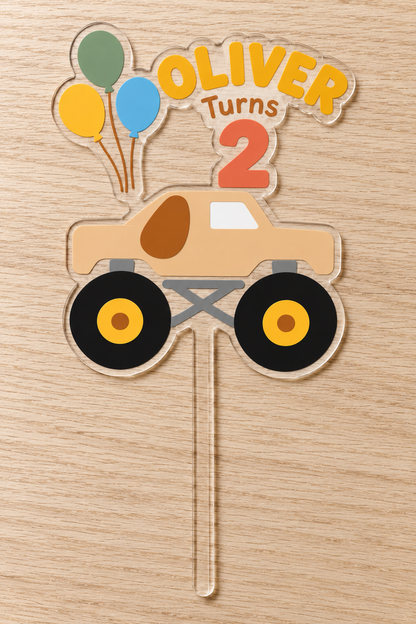 Personalized tan puppy monster truck birthday cake topper with custom name and age on clear acrylic
