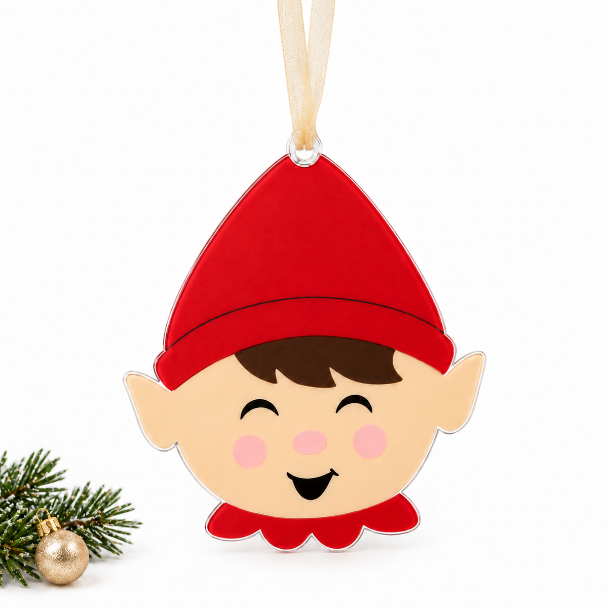 boy elf UV printed acrylic Christmas ornament in Tone 1 on a studio background, with sheer beige ribbon.