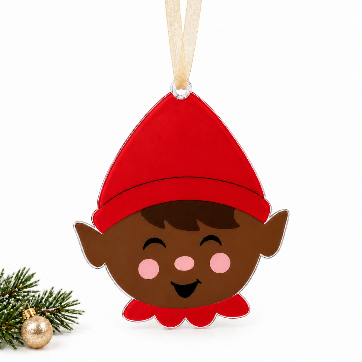 boy elf UV printed acrylic Christmas ornament in Tone 2 on a studio background, with sheer beige ribbon.