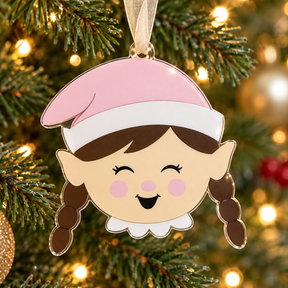 girl elf UV printed acrylic Christmas ornament hanging on a Christmas tree, with sheer beige ribbon.