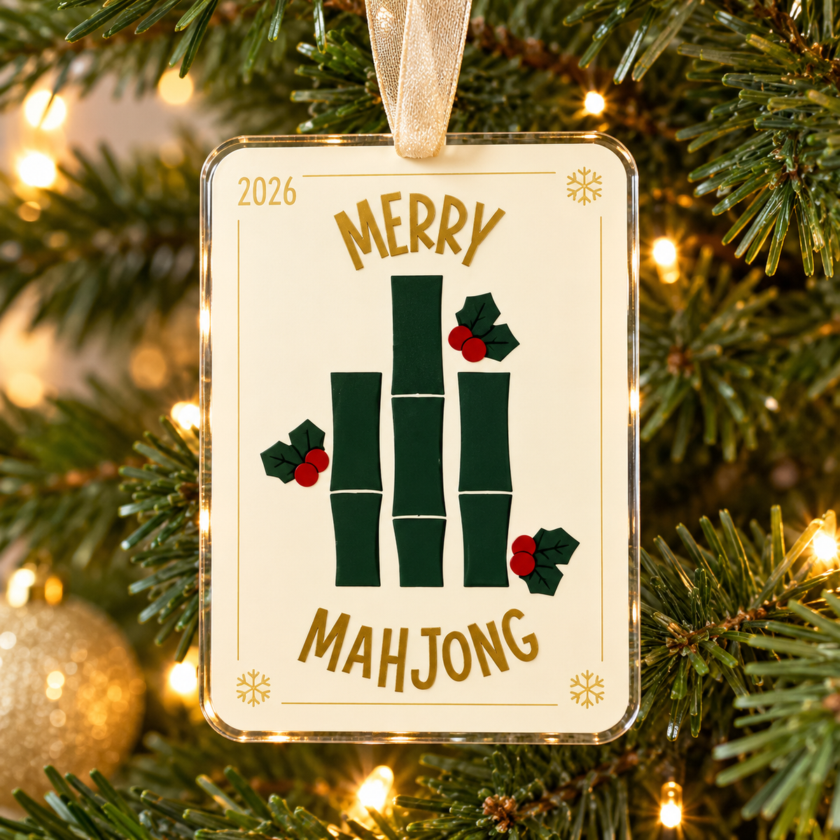 merry mahjong UV printed acrylic Christmas ornament hanging on a Christmas tree, with sheer beige ribbon.